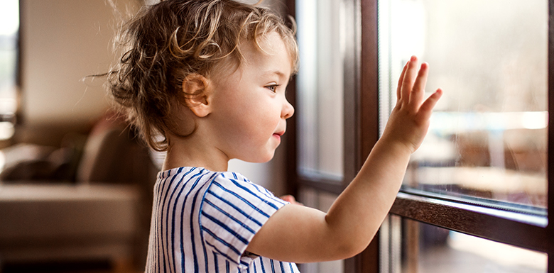 Child waving through glass image