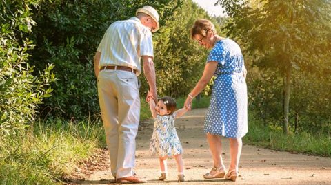 Grandparents walking with child