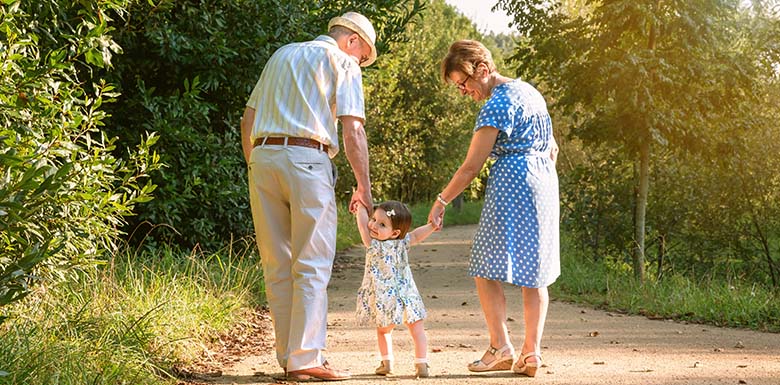 Grandparents walking with child