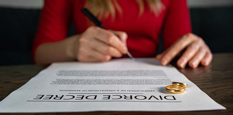 Woman in red signing divorce decree
