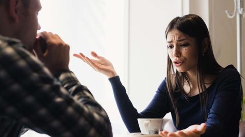 Woman yelling at man over coffee