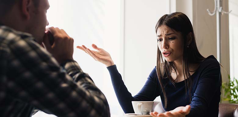 Woman yelling at man over coffee