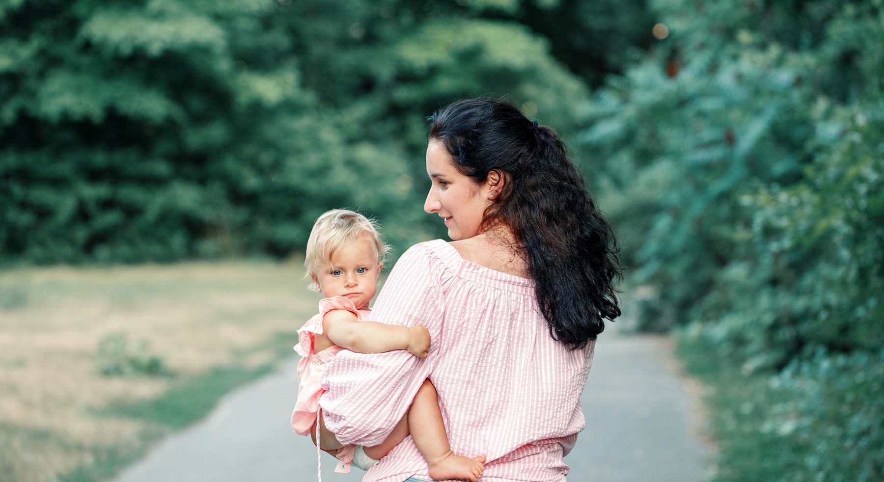 Mother walking with young daughter in park